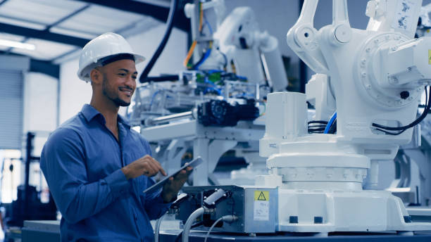 istock Engineer, man and happy with tablet robotics, machine learning and futuristic digital data. Engineering, employee and robot function check of African male worker on technology analysis for automation 1488640298