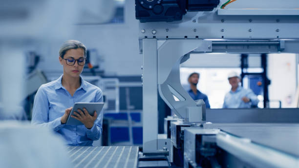 istock Tablet, factory and engineering woman with machine maintenance, programming or manufacturing in industry 4.0. Technician person working with metal, electronics or automation on digital technology app 1488640331