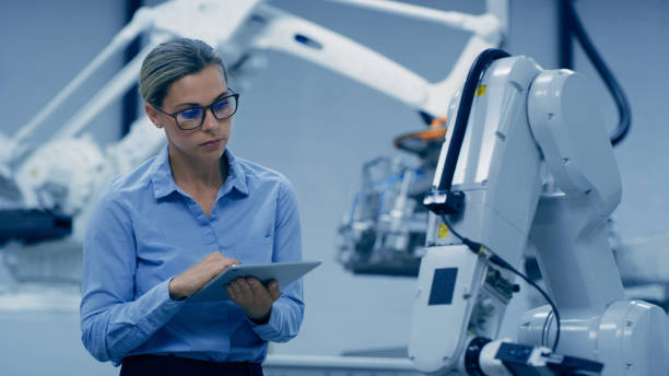istock Tablet, engineering and woman with robotic machine in lab for research, analytics and automation. Futuristic technology, industry 4.0 and female engineer on digital tech for manufacturing in factory 1488640886