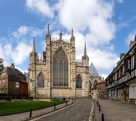 York Minster, York, UK - May 9, 2023.  An urban landscape view of the Great East Window of York Minster from St William's College in York, UK