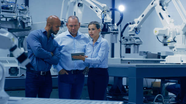 istock Engineering, tablet and team with automation machine for analysis, research and inspection. Technology, collaboration and men and woman on digital tech for robotic system, lab equipment and software 1488640913