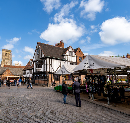 Shambles Market, York, UK - May 9, 2023.  A city view of The Shambles Markets in the centre of York city with historic architecture on a sunny day
