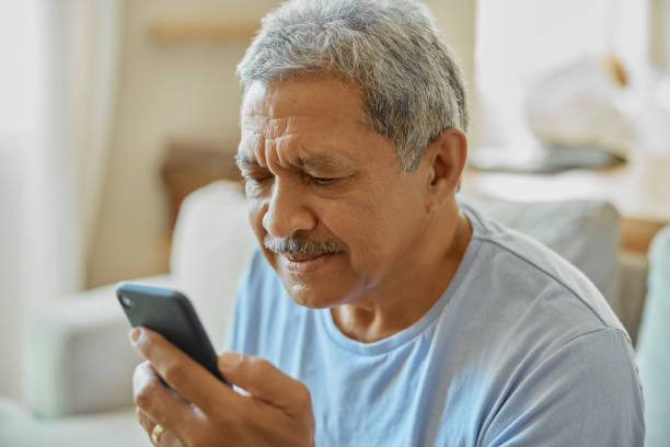 istock Senior man with smartphone, confused and reading message with vision problem or fail to understand app. Social media, communication and issue with technology and male person in retirement at home 1488641631