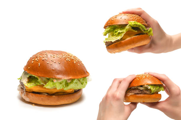 istock Hamburger in woman hands isolated on a white background. 1488642420