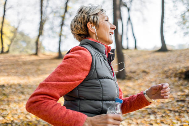 istock Senior woman jogging in park 1488642648