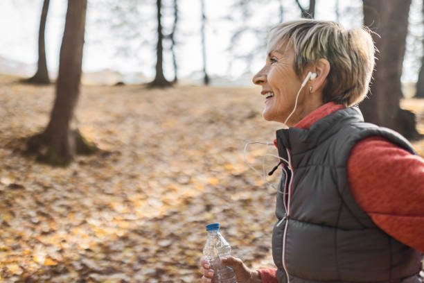 istock Senior woman jogging in park 1488642681