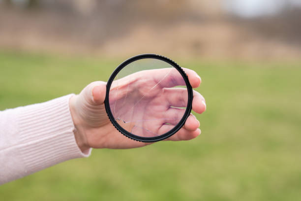 istock Cracked protective glass. Broken photo-filter of camera 1488642954