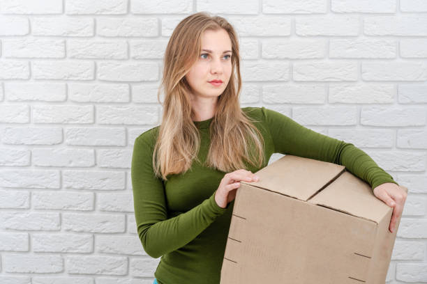 istock Attractive woman holding parcel box. Delivering a parcel 1488643934