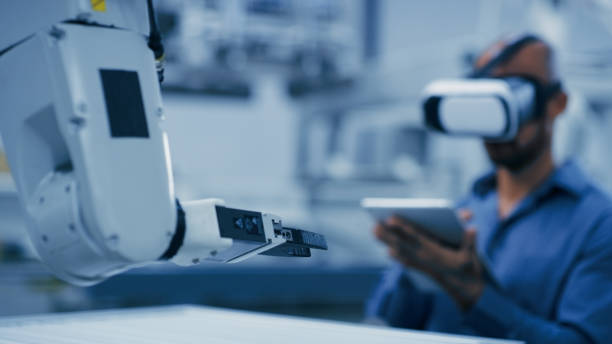 istock Engineering, robot arm and man with vr glasses and tablet for ai, futuristic electronics and manufacturing industry 4.0. Robotics workshop of technician person in digital, virtual reality and machine 1488644006
