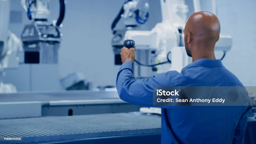 Ai, man testing robotic arm and futuristic technology, cyber automation and research in tech. Science, human and robot control, industrial cnc engineering with future innovation in machine awareness 35-39 Years Stock Photo