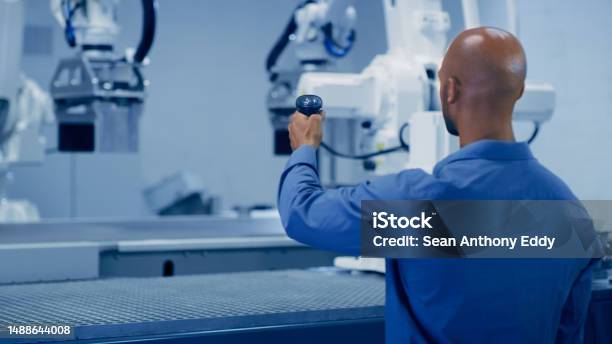 Ai Man Testing Robotic Arm And Futuristic Technology Cyber Automation And Research In Tech Science Human And Robot Control Industrial Cnc Engineering With Future Innovation In Machine Awareness Stock Photo - Download Image Now