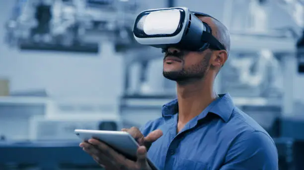 Photo of VR, glasses and engineering man on tablet for futuristic research, electronics management or software design. African person or technician in digital, virtual reality and tech in robotics laboratory