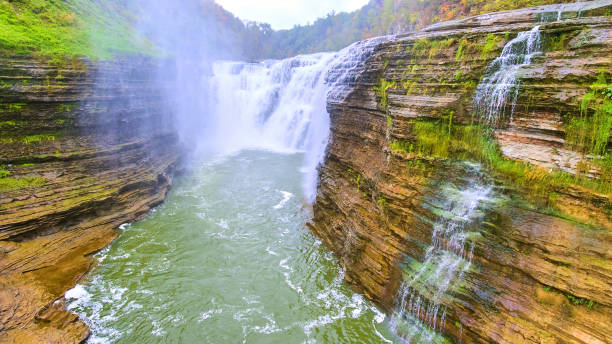 istock Aerial over raging river with waterfall carving into cliffs covered moss.jpg 1488644116