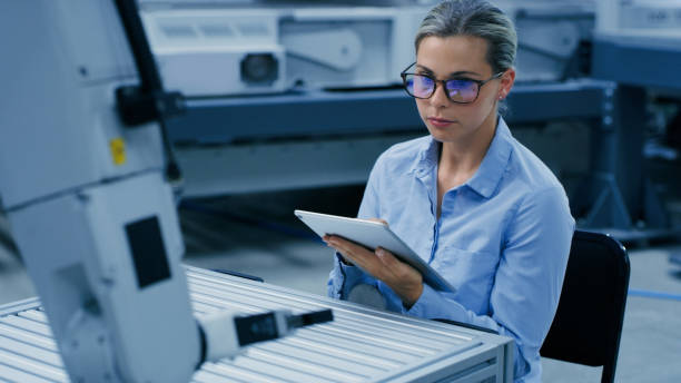 istock Robot control, engineering and woman on tablet in automation lab for research, analytics and inspection. Futuristic technology, industry 4.0 and female engineer on digital tech for robotic system 1488644384