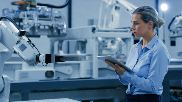 istock Woman, tablet and robotic engineering in automation for ai development or advanced technology in laboratory. Female engineer working with tech and robot arm for machine learning or control in lab 1488644391