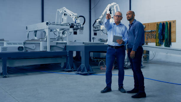 istock Engineering, tablet and men in lab planning with machine for analysis, research and automation. Technology, collaboration and engineer team on digital tech for robotic system, equipment and software 1488644395