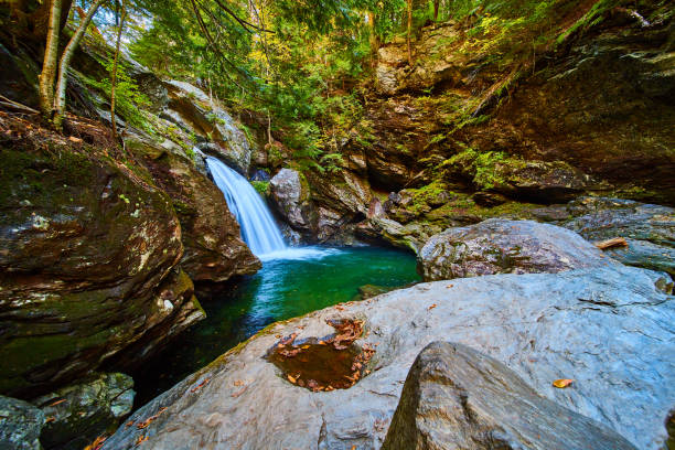 istock Beautiful blue waters from waterfall over cliffs surrounded in boulders with moss and fall leaves.jpg 1488644719