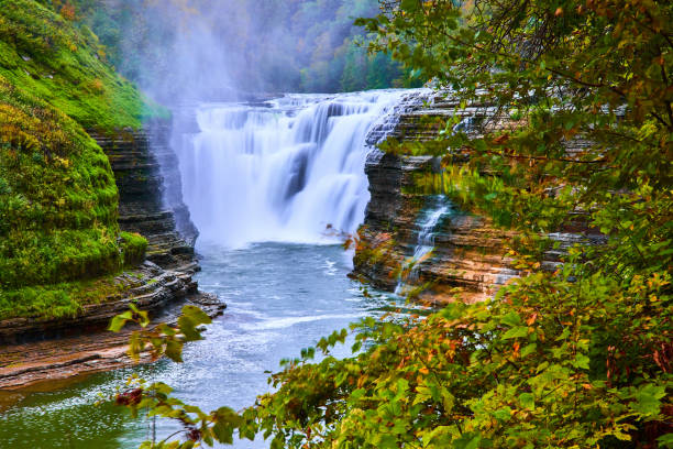 istock Beautiful misty large waterfall through trees carving into rocky cliffs.jpg 1488645105