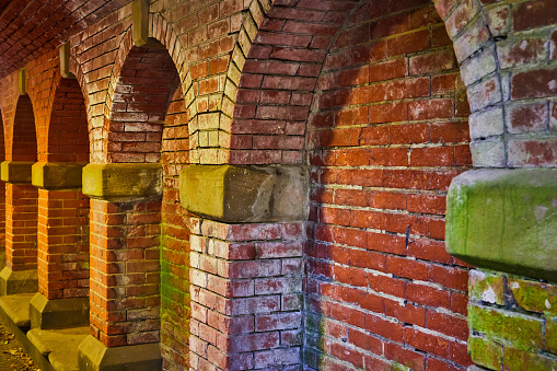 Image of Brick wall with faded white and moss and arches in Central Park New York City