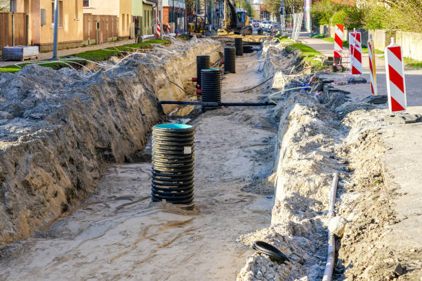 istock Street reconstruction with underground pipes replacement, deep trench with large plastic wells 1488647633