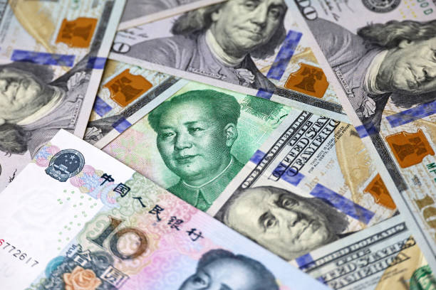 istock Chinese yuan banknotes and US dollars 1488649301