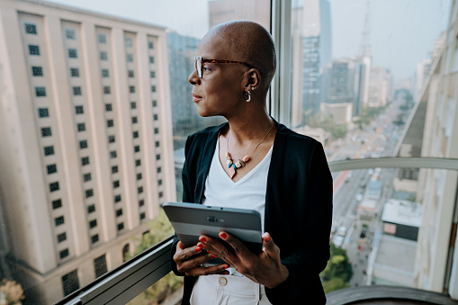 Portrait of a black businesswoman looking at cityscape