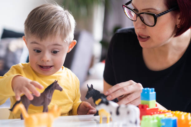 istock parent bonding with their child with Down syndrome through an educational and stimulating activity 1488653008
