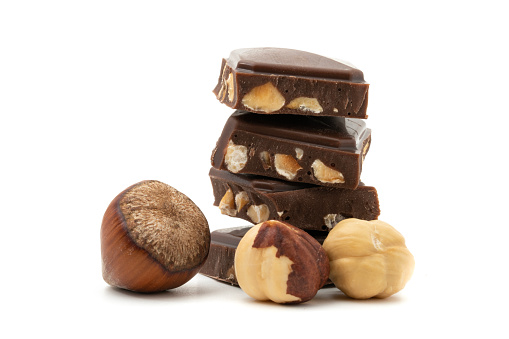 Chocolate with hazelnuts isolated on white background