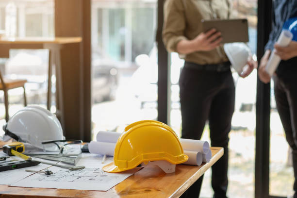 istock Asian engineers brainstorm and measure to document cost estimates and write floor plans for architectural and engineering designs for houses and buildings. 1488654155