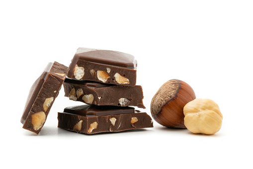 Chocolate with hazelnuts isolated on white background