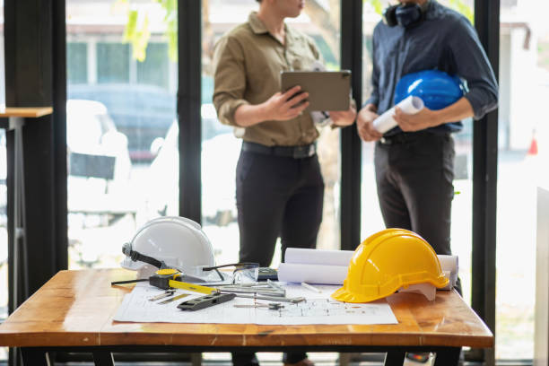 istock Asian engineers brainstorm and measure to document cost estimates and write floor plans for architectural and engineering designs for houses and buildings. 1488654877