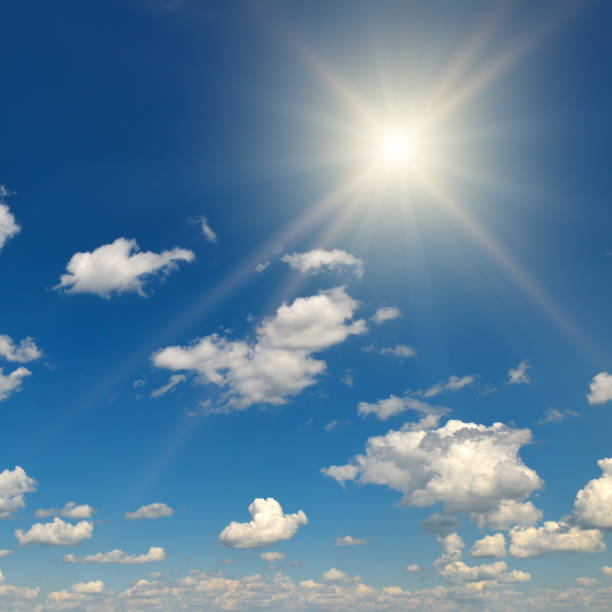istock Bright sun on beautiful blue sky with white clouds. 1488661211