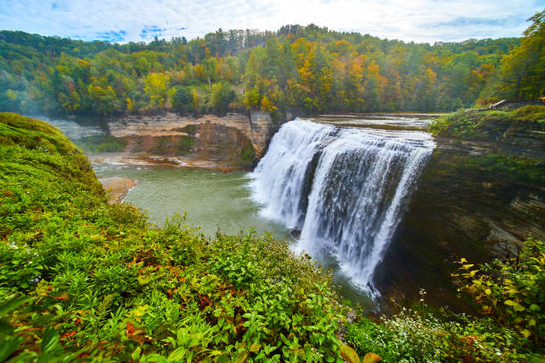 istock Huge waterfall wide angle up close pouring over cliffs into canyon in lush green forest with hints of approaching fall.jpg 1488664421