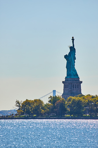 Image of Iconic American Statue of Liberty from back in shade vertical