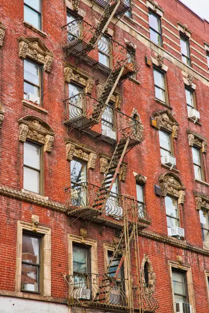 Photo of Looking up old red brick apartment building in New York City with stairs zig zagging up side.jpg
