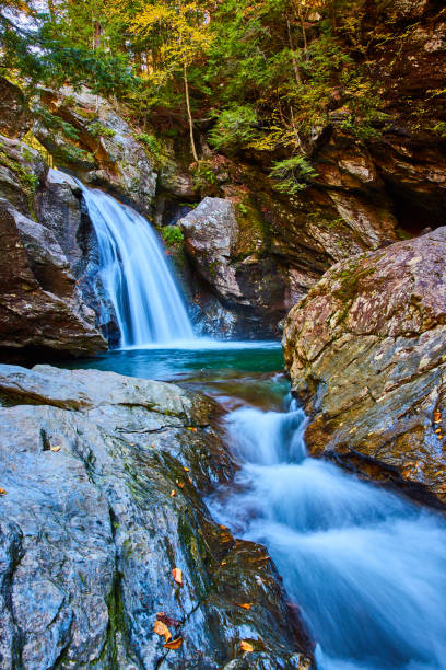 istock Looking up raging river through boulders with waterfall over mossy cliffs in forest.jpg 1488665084