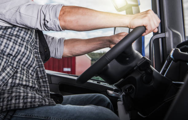 istock Professional Semi Truck Driver Behind the Tractor Wheel 1488665900