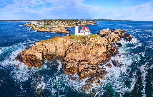 Image of Nubble Lighthouse island off of Maine coast with ocean waves