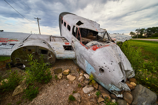 Image of Old abandoned crashed plane in fields on cloudy day