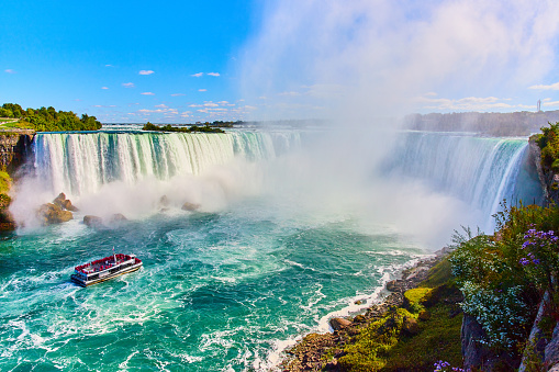 Image of Stunning Niagara Falls view of Horseshoe Falls with ship for tourists approaching mist