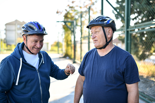 Two Senior Males With Helmets Preparing For Extreme Sports
