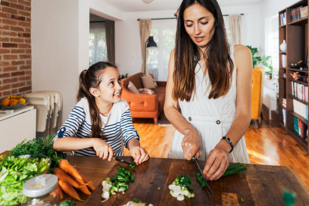 istock Mother and daughter cooking together 1488671885
