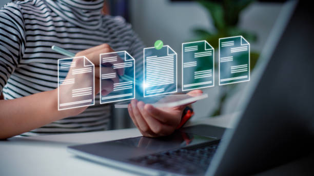 istock Prepare check and approve concepts. Document management, paperless. Women touching on virtual screen to tick mark documents for online approve paperless quality assurance and ERP management. 1488672361