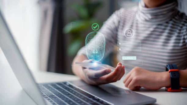 istock Woman scans face using facial recognition system on mobile phone for biometric identification. Future high tech technology and face id 1488672407