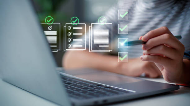 istock Prepare check and approve concepts. Document management, paperless. Women touching on virtual screen to tick mark documents for online approve paperless quality assurance and ERP management. 1488672416