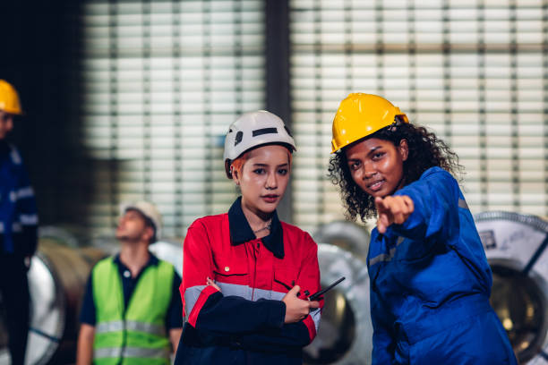 istock Foreman or worker work at factory site check up machine or products in site. 1488672555
