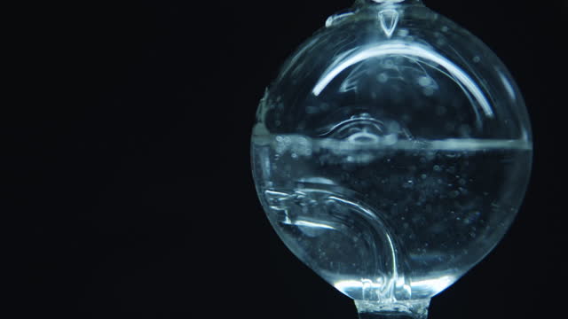 Boiling water in a spherical flask.