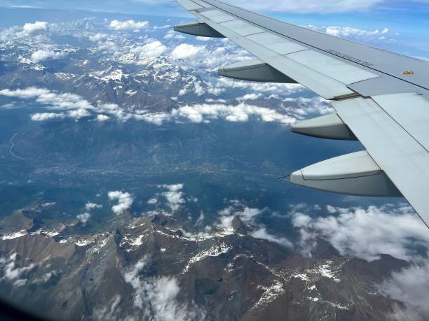istock Wing of plane over mountain cover with some snow 1488673711