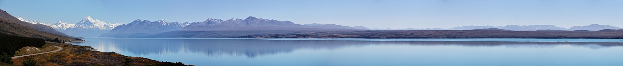 Panoramic view of the stunning Lake Pukaki in New Zealand, featuring a magnificent snow-capped mountain in the background
