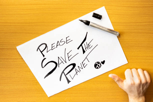 istock Okey Hand with card on table SAVE THE PLANET, Message on cardboard Save The Planet, Concept of hand writing on cardboard SAVE THE EARTH 1488676185